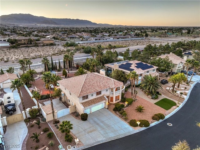 aerial view at dusk with a mountain view and a residential view