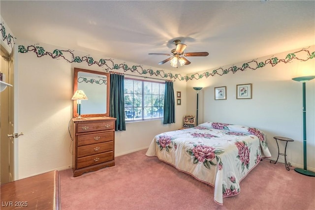 carpeted bedroom with a ceiling fan and baseboards