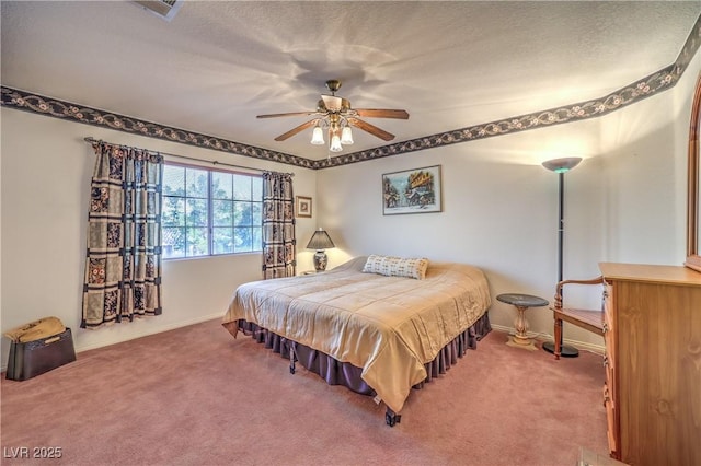 carpeted bedroom with visible vents, baseboards, a textured ceiling, and a ceiling fan