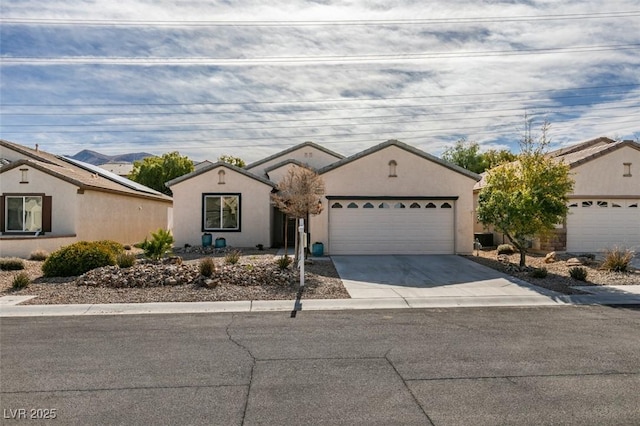 single story home with a garage, concrete driveway, and stucco siding