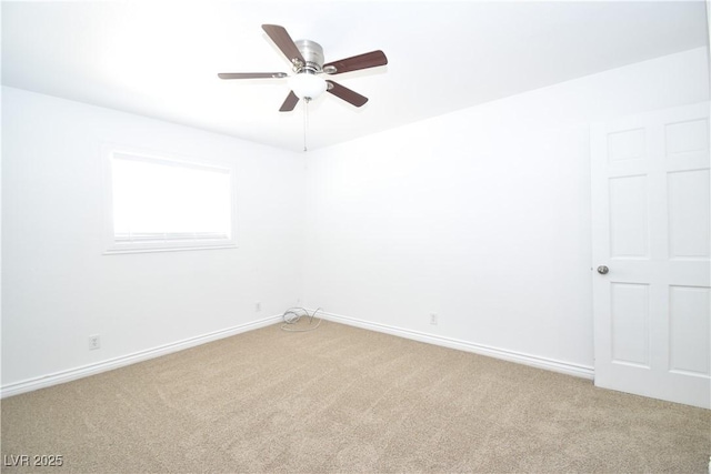 spare room with light carpet, ceiling fan, and baseboards