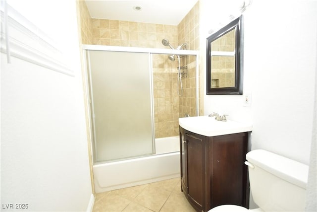 bathroom with tile patterned flooring, vanity, toilet, and bath / shower combo with glass door