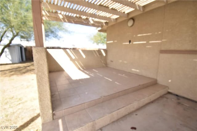 view of patio / terrace with an outdoor structure and a pergola