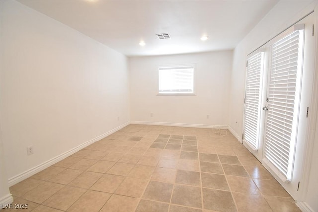 empty room with recessed lighting, visible vents, baseboards, and light tile patterned floors