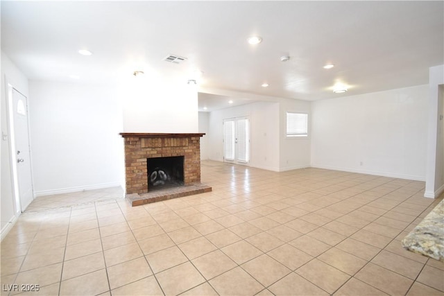 unfurnished living room featuring recessed lighting, a brick fireplace, light tile patterned flooring, and visible vents