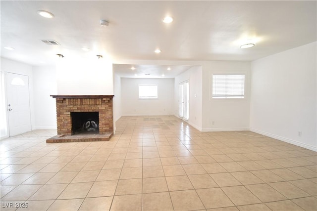 unfurnished living room with light tile patterned flooring, recessed lighting, visible vents, baseboards, and a brick fireplace