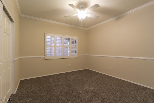 carpeted empty room featuring ceiling fan, baseboards, and crown molding