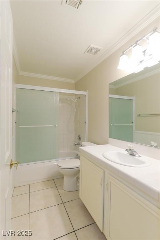 full bath with toilet, ornamental molding, vanity, and tile patterned floors