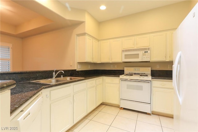 kitchen with white appliances, light tile patterned floors, white cabinetry, a sink, and recessed lighting