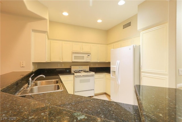 kitchen with recessed lighting, white appliances, a sink, visible vents, and white cabinets