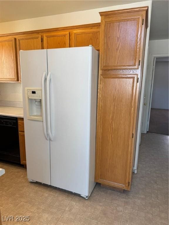 kitchen with white fridge with ice dispenser, brown cabinetry, light countertops, and dishwasher