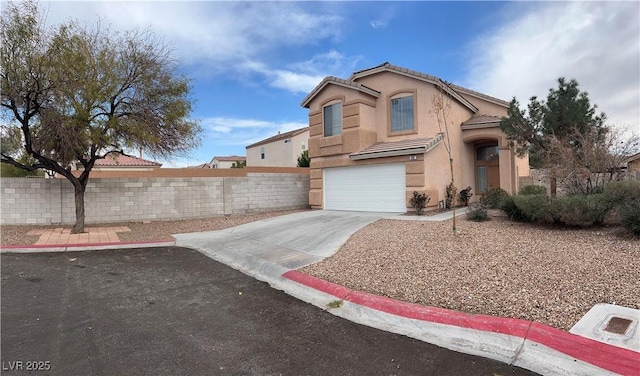 view of front of property featuring a tiled roof, fence, concrete driveway, and stucco siding