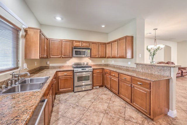 1332 Cedar Berry Ct, Henderson, NV 89012 - kitchen featuring stainless steel appliances, a sink, a peninsula, brown cabinets, and recessed lighting
