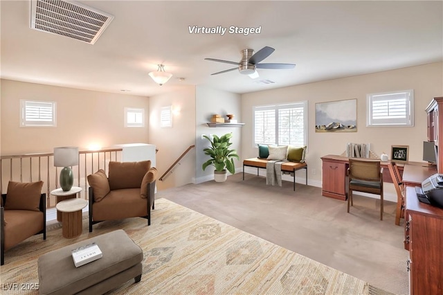 1332 Cedar Berry Ct, Henderson, NV 89012 - living room featuring plenty of natural light, a ceiling fan, light colored carpet, and baseboards
