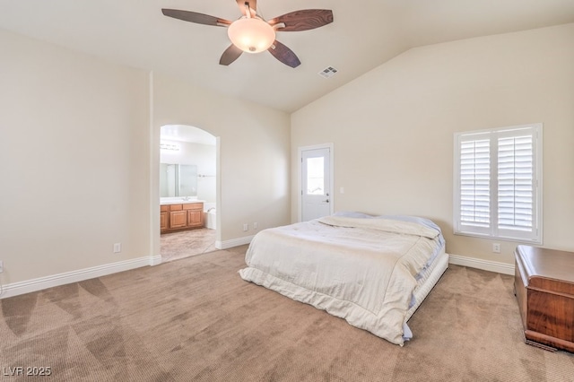1332 Cedar Berry Ct, Henderson, NV 89012 - bedroom featuring arched walkways, lofted ceiling, light colored carpet, baseboards, and connected bathroom