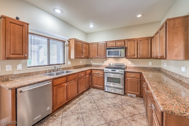 1332 Cedar Berry Ct, Henderson, NV 89012 - kitchen with appliances with stainless steel finishes, a sink, brown cabinetry, recessed lighting, and light stone counters