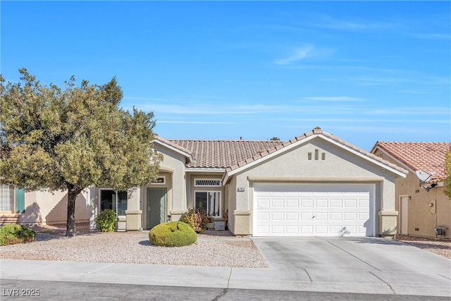 view of front of house featuring a garage, a tiled roof, concrete driveway, and stucco siding