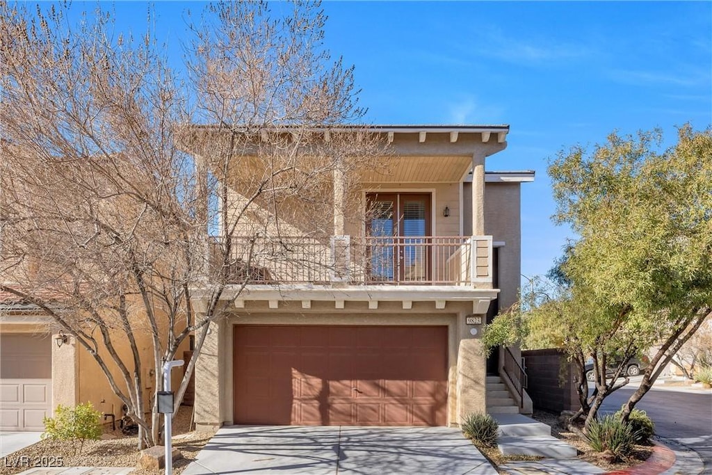 view of front of house with a balcony, a garage, concrete driveway, and stucco siding