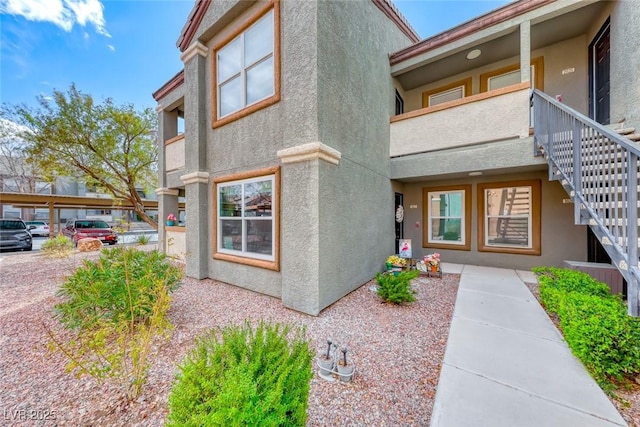 view of exterior entry with stucco siding