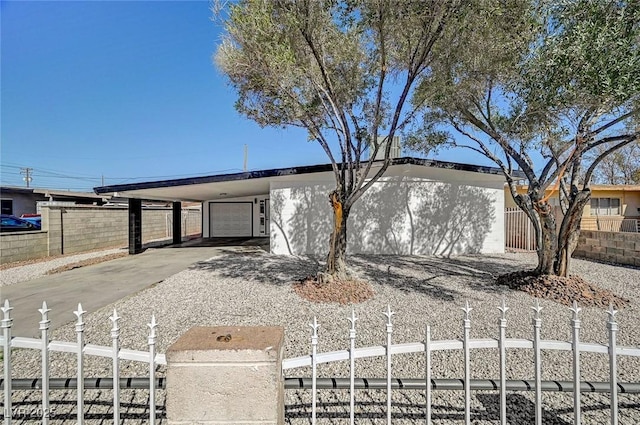 view of front of home with a garage, fence, and driveway