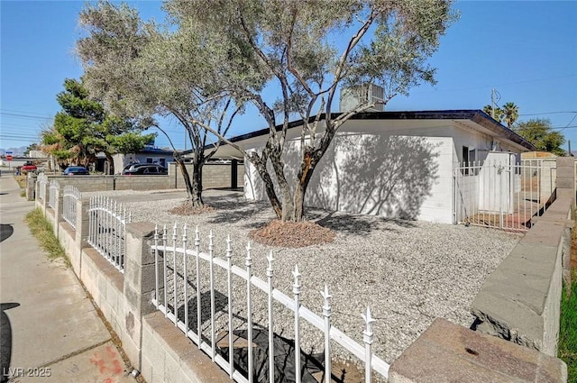 view of front of house featuring a fenced front yard and concrete block siding