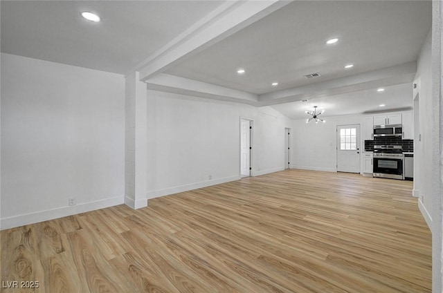 unfurnished living room featuring light wood finished floors, baseboards, visible vents, and an inviting chandelier