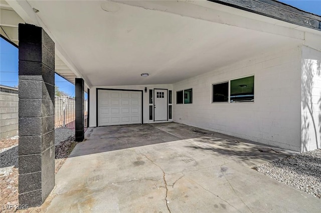 exterior space with concrete block siding and fence