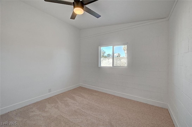 spare room featuring ceiling fan, baseboards, and light colored carpet