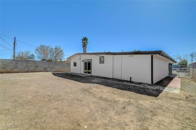 back of house featuring a fenced backyard