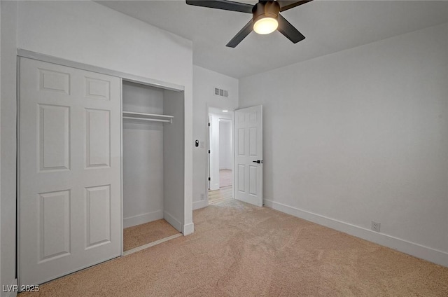 unfurnished bedroom with baseboards, visible vents, a ceiling fan, carpet, and a closet