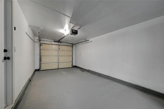 garage featuring a garage door opener and baseboards