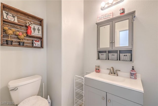 half bathroom featuring toilet and vanity