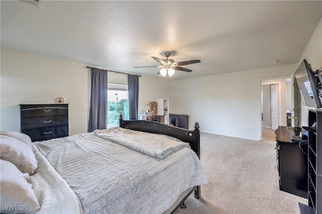 bedroom featuring a ceiling fan and carpet