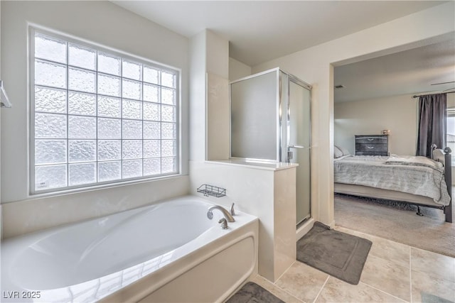 bathroom featuring a bath, a shower stall, connected bathroom, and tile patterned floors