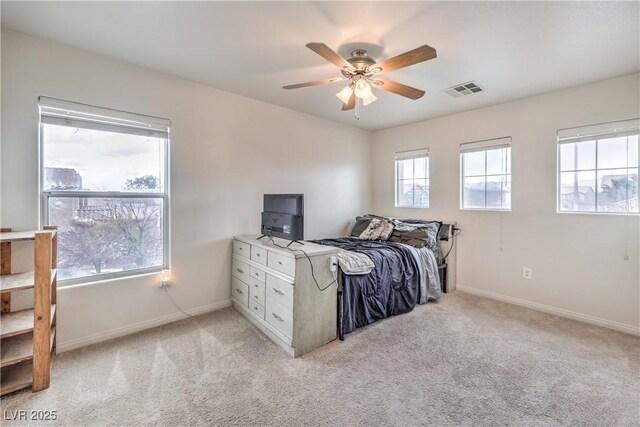 bedroom featuring light carpet, a ceiling fan, visible vents, and baseboards