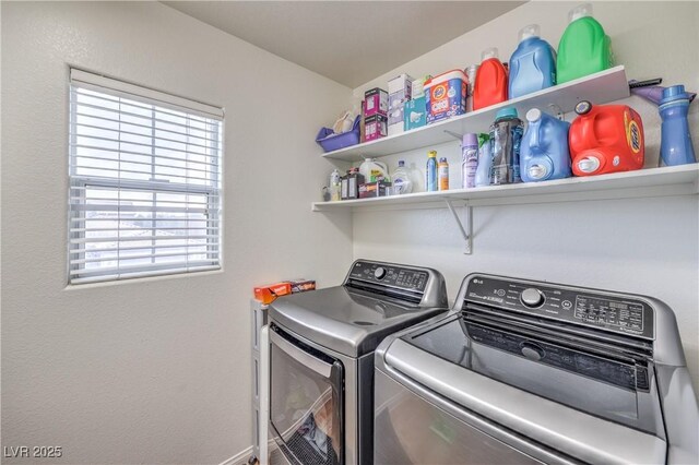 clothes washing area featuring laundry area and washer and clothes dryer