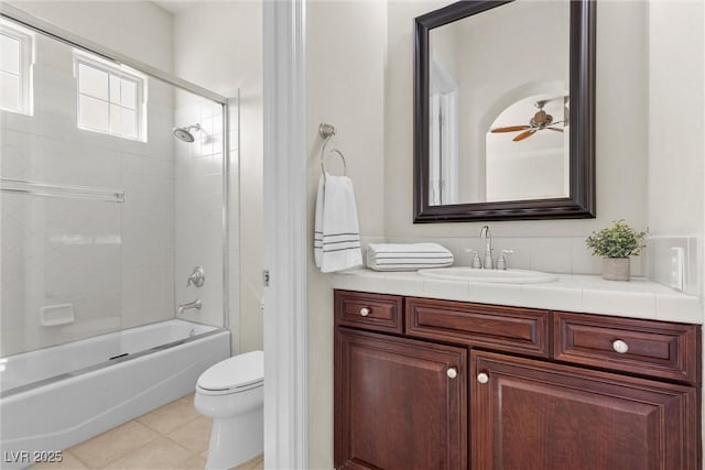 full bath with a ceiling fan, toilet, shower / tub combination, tile patterned floors, and vanity