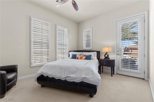 bedroom with multiple windows, carpet flooring, and access to exterior