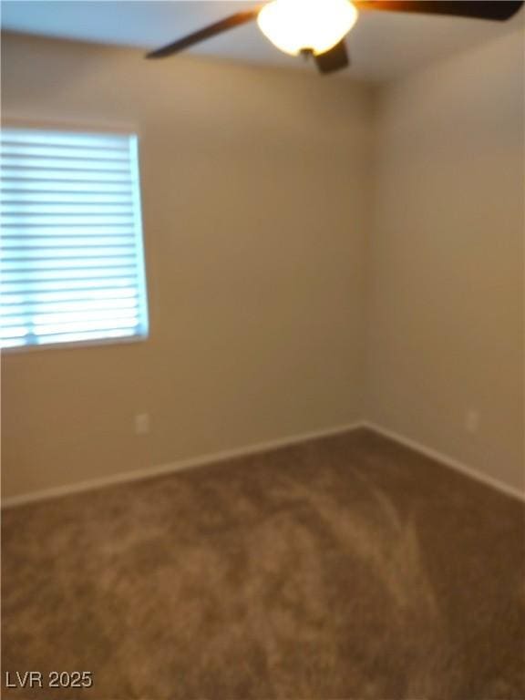 unfurnished room featuring baseboards, a ceiling fan, and carpet flooring