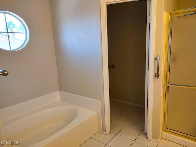 full bath featuring a stall shower, a bath, and tile patterned floors