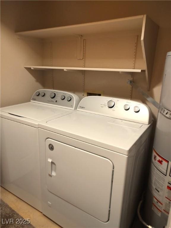 clothes washing area featuring laundry area, strapped water heater, and separate washer and dryer