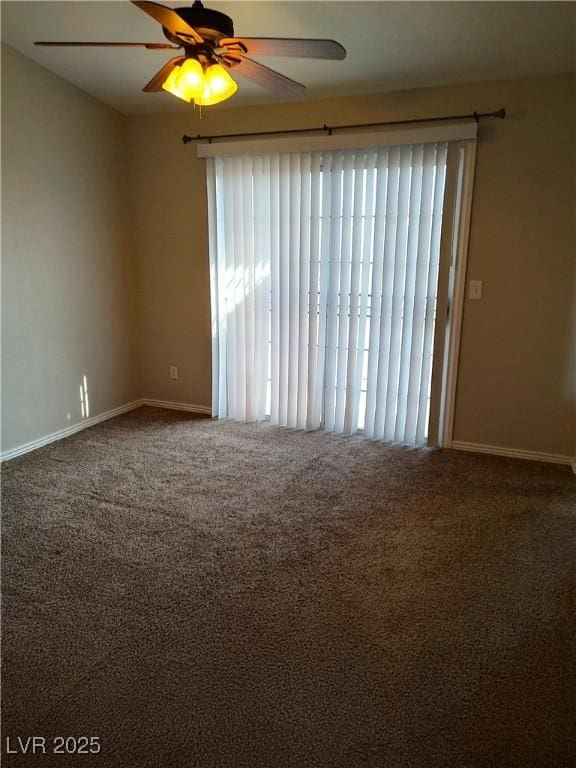 carpeted empty room with ceiling fan and baseboards