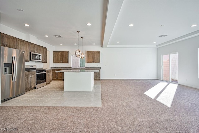 kitchen featuring light carpet, visible vents, appliances with stainless steel finishes, and open floor plan