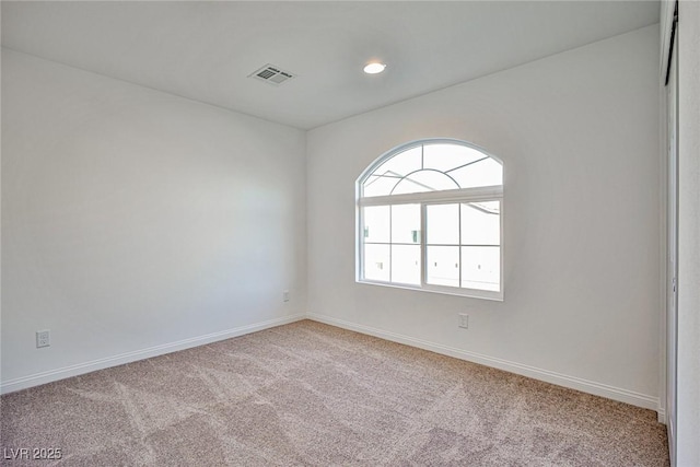 spare room featuring light carpet, baseboards, visible vents, and recessed lighting