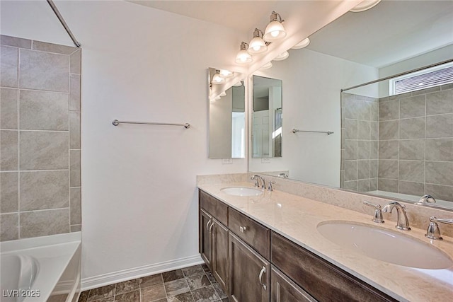 full bath featuring double vanity, baseboards,  shower combination, and a sink