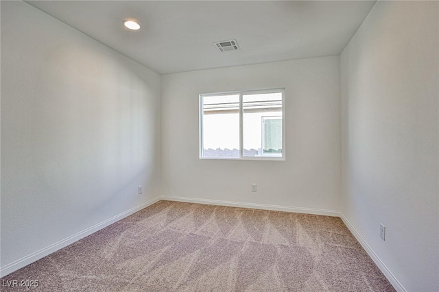 spare room with carpet, visible vents, baseboards, and recessed lighting