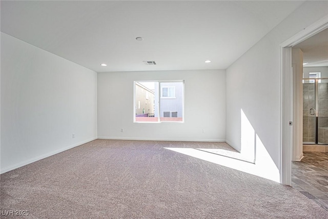 carpeted spare room featuring recessed lighting, visible vents, and baseboards