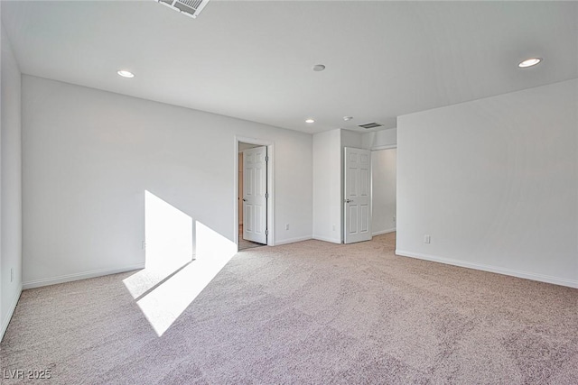 unfurnished room with light carpet, visible vents, baseboards, and recessed lighting