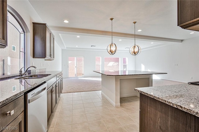 kitchen with dark brown cabinetry, a sink, open floor plan, stainless steel dishwasher, and beam ceiling