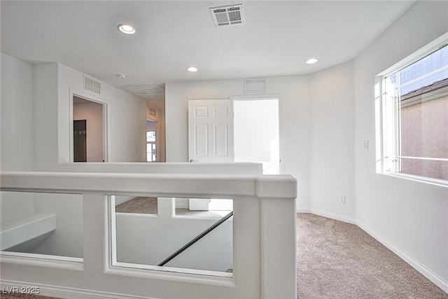 corridor featuring carpet floors, visible vents, and recessed lighting